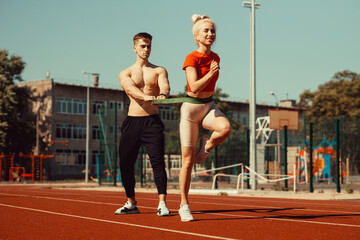 Young couple doing sports with sports rubber bands