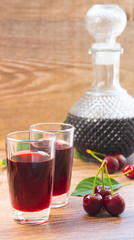 Decanter and glasses with cherry liqueur or wine on the table