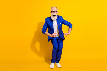 Fototapeta premium Full length body size photo of overjoyed cool senior man chilling relaxing at party isolated on vibrant yellow color background