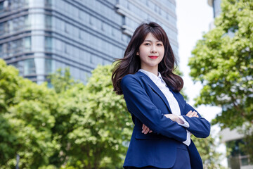 Beautiful Asian woman outdoors, wearing a suit