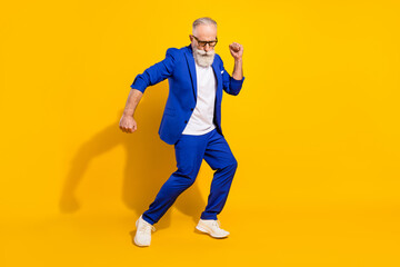 Fototapeta na wymiar Full size photo of positive grey beard elder man dance wear spectacles blue jacket isolated on yellow background