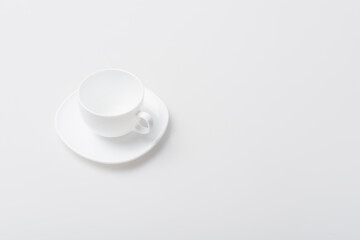 top view of empty ceramic cup and saucer isolated on white