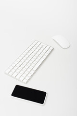 smartphone with blank screen near computer mouse and keyboard isolated on white