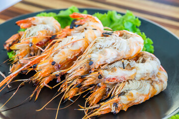 Grilled river prawn on dish. Flame grilled prawns on plates. Local food in Thailand. Regional Food Backgrounds