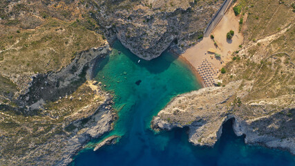 Aerial drone top down photo of heart shaped bay forming a lovers cove with emerald crystal clear sandy beach
