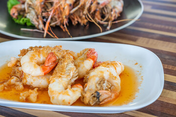 Fried Shrimp with Garlic and Pepper on white dish. Local food in Thailand. Regional Food Backgrounds