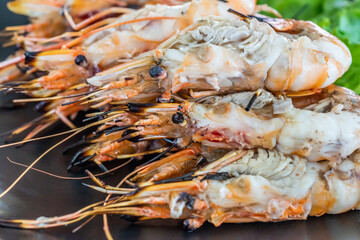 Grilled river prawn on dish. Flame grilled prawns on plates. Local food in Thailand. Regional Food Backgrounds