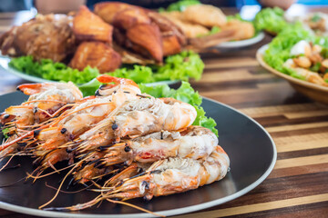 Grilled river prawn on dish. Flame grilled prawns on plates. Local food in Thailand. Regional Food Backgrounds