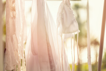 Closeup hanging laundry on balcony on the drying rack at sunset sunshine
