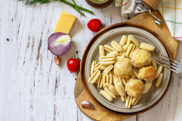 Italian pasta, keto diet lunch. Spaghetti with meatballs in cheese sauce on a wooden table. Top view, flat lay background. Copy space.
