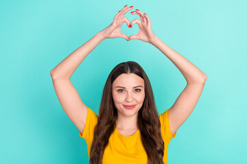 Fototapeta na wymiar Photo of cool young lady show heart by hands wear yellow t-shirt isolated on vivid teal color background