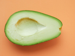 Organic avocado with seeds, avocado halves and whole fruit on a yellow background. Top view. Pop art design, creative concept of summer food.