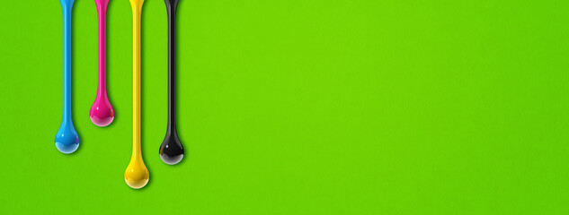 cmyk ink drops on green paper banner background