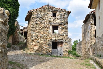 Fototapeta na wymiar Old house built in dry stone in the town square of Villarijo. Currently abandoned, Soria province, Spain.