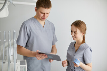 Group of cheerful healthcare workers working together at doctor's office.