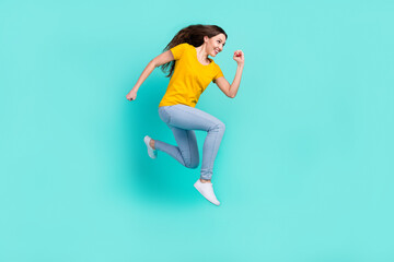 Fototapeta na wymiar Full body profile photo of funny young lady run wear yellow t-shirt jeans isolated on teal color background