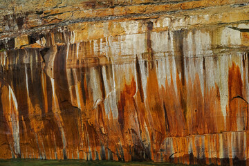 Landscape of mineral stained cliff along the eroded sandstone shoreline of Lake Superior, Pictured Rocks National Lakeshore, Michigan’s Upper Peninsula, USA