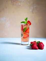 A glass of strawberry mojito with mint on the white background