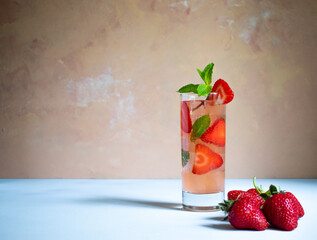 A glass of strawberry mojito with mint on the white background