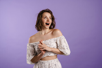 Fototapeta premium Excited young woman gesturing while expressing surprise