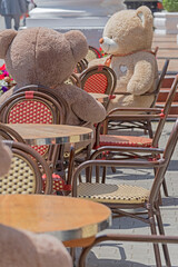 Teddy bears sitting in coffee shop