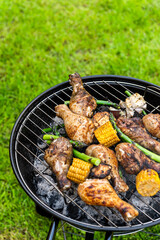 Grilled Food on Charcoal BBQ. Summer Picnic in Backyard Garden
