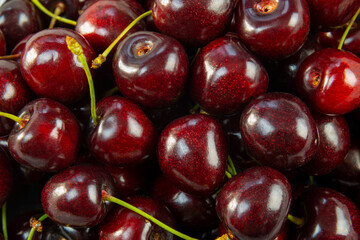 Exotic black large cherry background with close up on several berries.