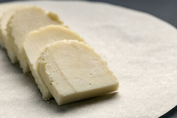 cheese tasting, sliced cheese on a paper backing