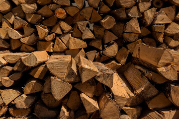 Chopped firewood. Stacked wood close-up. Natural wooden background, wall firewood