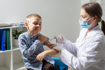 Portrait of lovely brave preschooler boy while routine vaccination