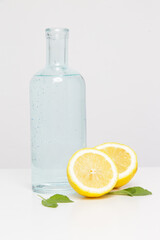 Regular tap water in reusable glass bottle with lemon slices. Healthy detox drink.