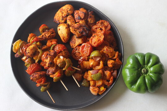 Air fried chicken and bell peppers in skewers. Boneless chicken cubes marinated with yogurt and spices and Air fried along with bell peppers.