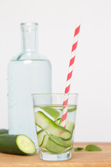 Cucumber detox water with colorful paper straw. Healthy detox drink.	