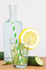 Lemon cucumber water with colorful paper straw. Healthy detox drink.