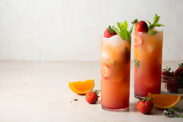 Pink lemonade with fresh strawberries, orange fruit and mint. Fresh summer fruit cocktails.