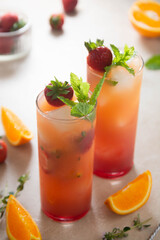 Strawberry lemonade with fresh orange fruit and mint. Fresh summer fruit cocktails.