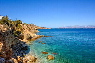 Fototapeta na wymiar Rocky cliffs on the coast of Piso Livadi. Beautiful bay overlooking the island of Naxos. Paros, Greece