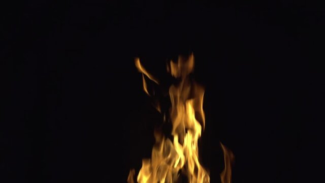 The tip of the flame of the fire, captured on camera, slowed down in four times against a black background.