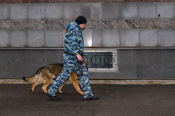 Female police officers with a trained dog. German shepherd police dog.