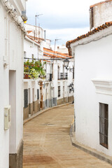 Fototapeta na wymiar Cobbled street and houses in the town of Aroche, Huelva, Spain 