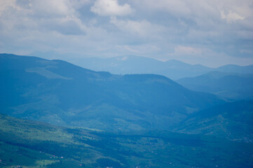 Fototapeta premium The village among the mountains in the sun and rain