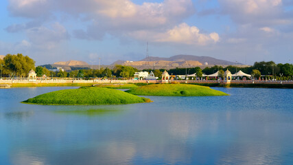 Rose Garden park view with blue sky and water body, Muscat Oman