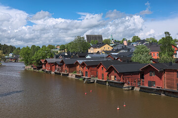 Fototapeta na wymiar Porvoo Old Town with old wooden barns alongside the Porvoonjoki river, Finland. View from a bridge across the river.