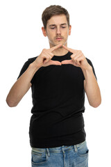 Young handsome tall slim white man with brown hair with joined thumbs and pointing fingers in black shirt isolated on white background