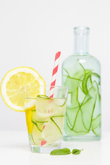Lemon cucumber water with colorful paper straw. Healthy detox drink.