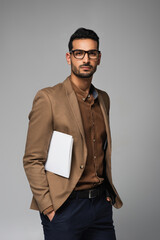 Fototapeta premium Muslim businessman with papers looking at camera isolated on grey