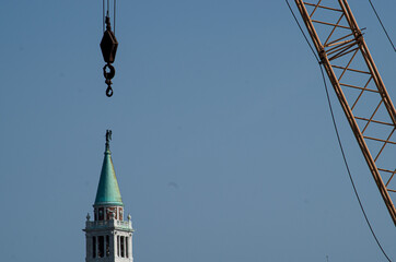 venice dayly construction woks with the hook on a bell tower 