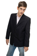 Young handsome tall slim white man with brown hair in black blazer in blue jeans isolated on white background