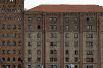 series of windows looking and the grand Canal in Venice in a building made of bricks