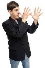 Young handsome tall slim white man with brown hair doing long nose with both hands in black blazer isolated on white background